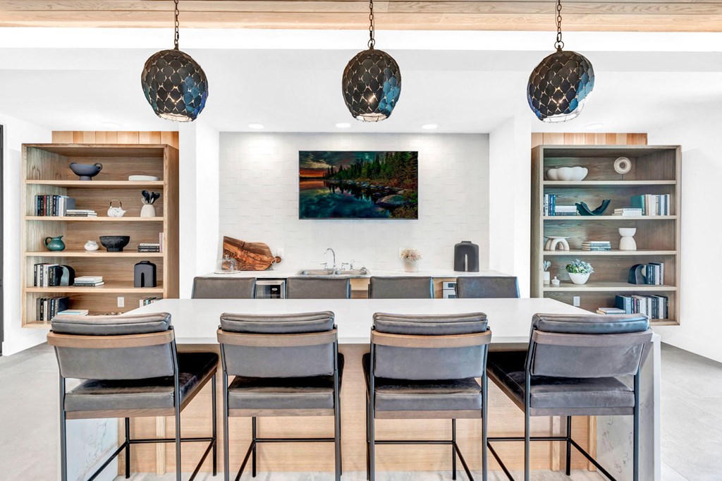 a dining room with a table and chairs and a mirror