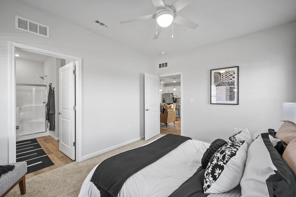 a bedroom with a bed and a ceiling fan