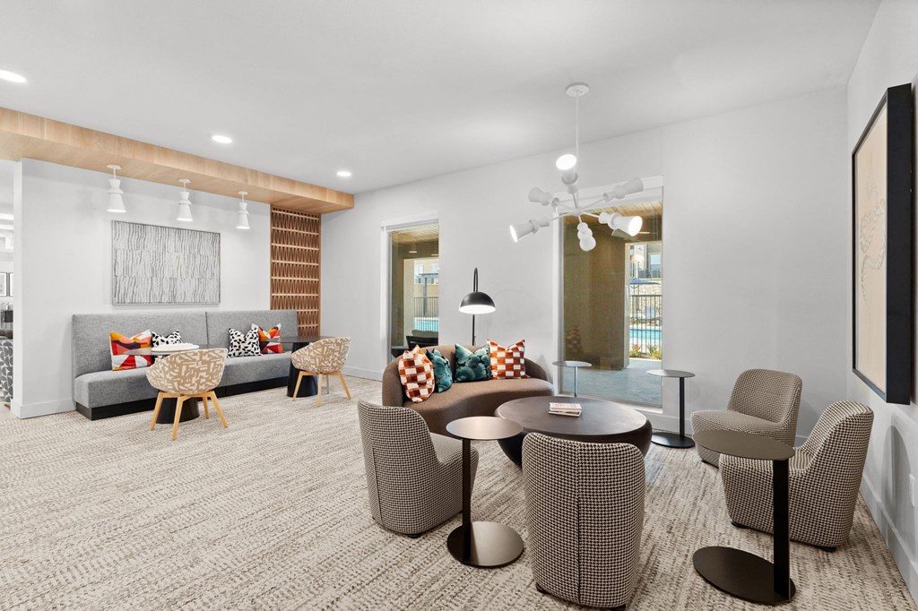a room with a couch and chairs and a table