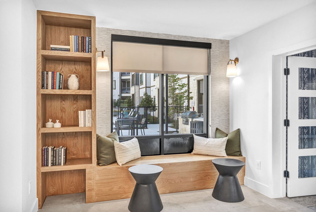 a room with a window seat and a large window