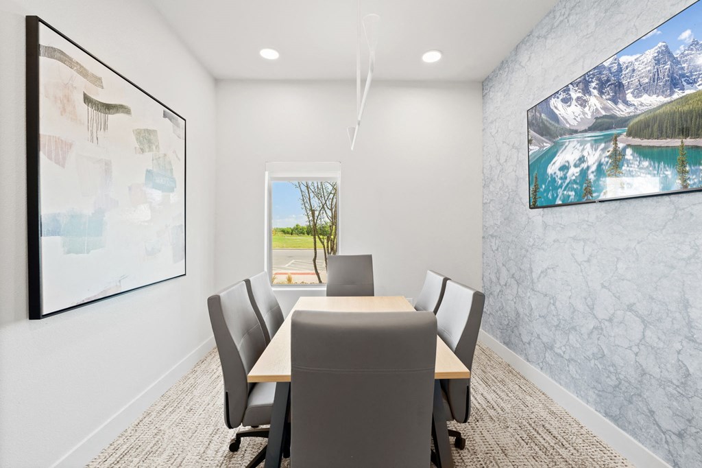 a conference room with a table and chairs