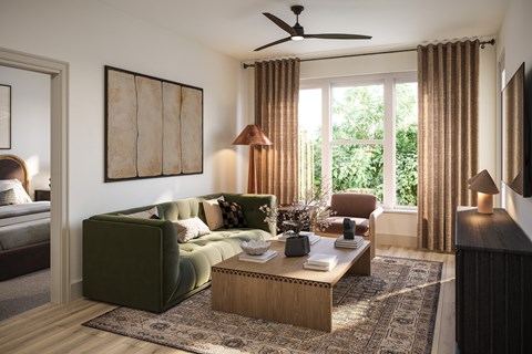 A living room with a green couch and a wooden coffee table.