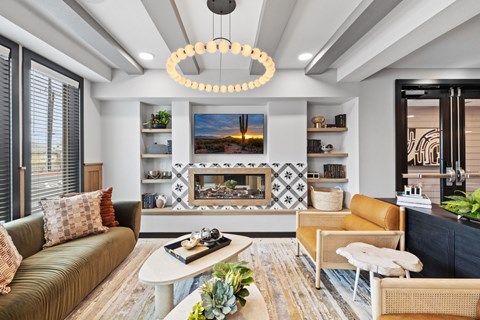 A modern living room with a fireplace and a large painting above it.