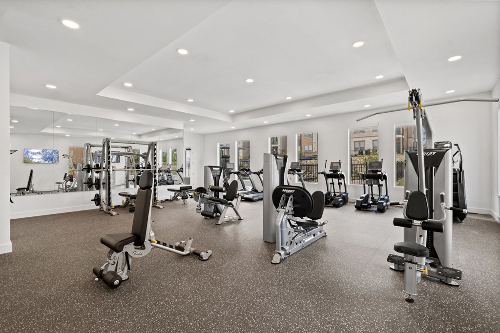a gym with weights and other exercise equipment in a large room