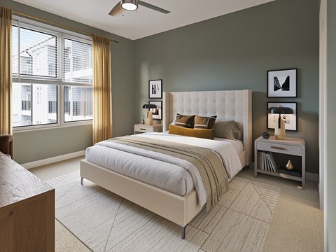 A bedroom with a large bed and a window with curtains.