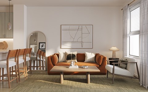 A living room with a large painting on the wall and a coffee table in the center.