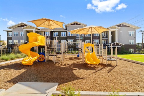 Community playground featuring modern play equipment, slides, and a welcoming outdoor space for recreation and exploration.