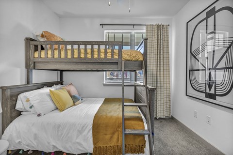 Warm and welcoming bedroom with natural light, textured accents, and a calm, restful layout.