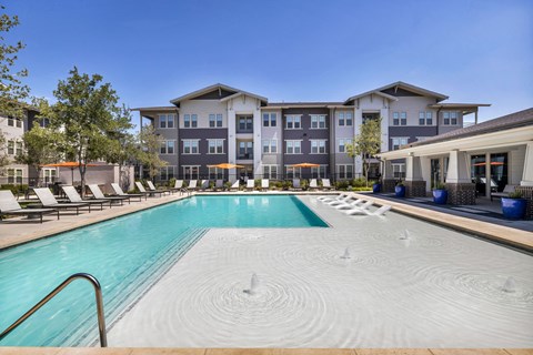 Resort-style swimming pool with comfortable lounge seating and a beautifully maintained outdoor space designed for relaxation.