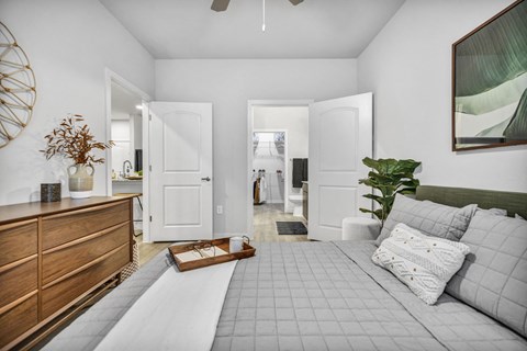 Spacious primary bedroom featuring comfortable furnishings, abundant natural light, and a relaxing atmosphere designed for everyday comfort.