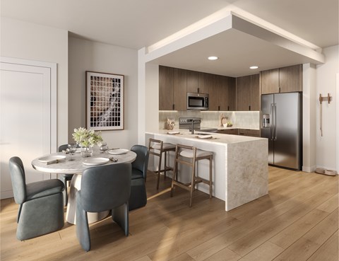A modern kitchen with a dining table and chairs.
