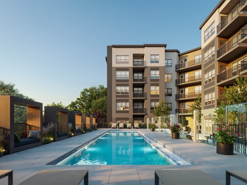 A swimming pool in front of apartment buildings.