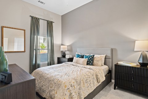 Primary bedroom featuring an en-suite bathroom, walk-in closet, and contemporary interior finishes.