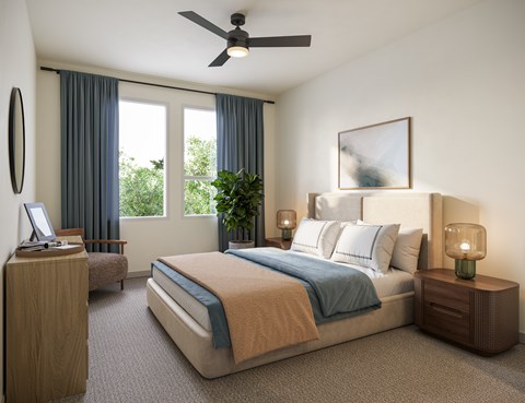 A bedroom with a large bed and a ceiling fan.