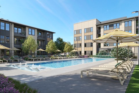 A large swimming pool surrounded by lounge chairs and umbrellas in front of apartment buildings.