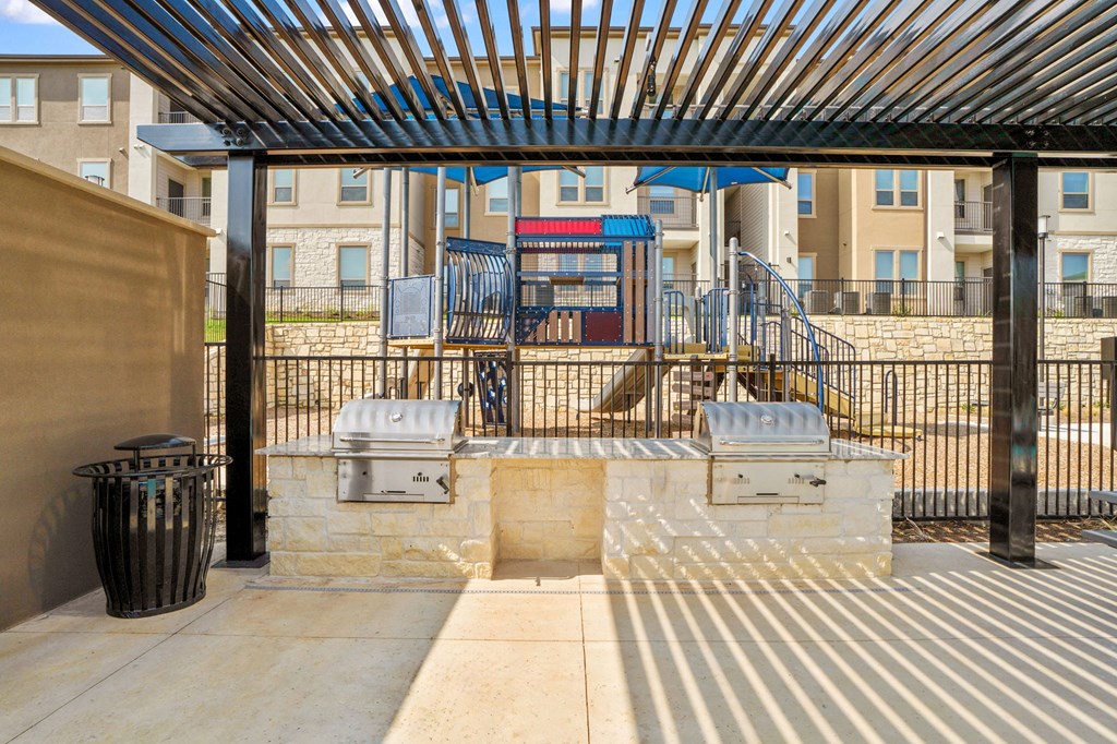 our apartments have a patio with a grill and a playground