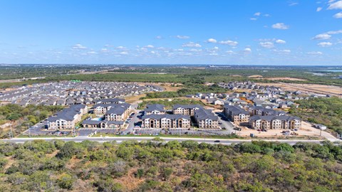 an aerial view of an apartment complex with trees
