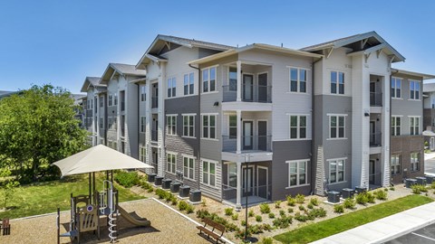 Modern apartment community featuring contemporary architecture, beautifully maintained landscaping, and inviting curb appeal.