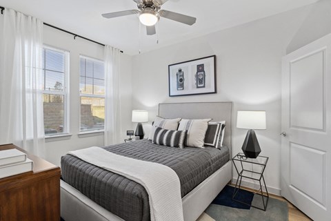 Spacious primary bedroom featuring comfortable furnishings, abundant natural light, and a relaxing atmosphere designed for everyday comfort.