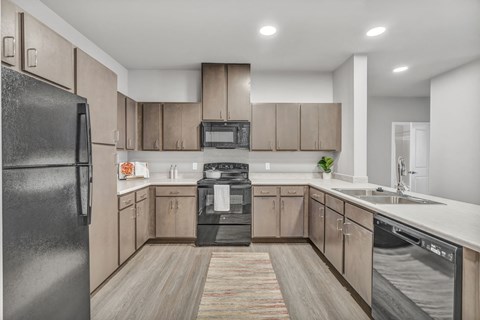 a kitchen with wooden cabinets and stainless steel appliances