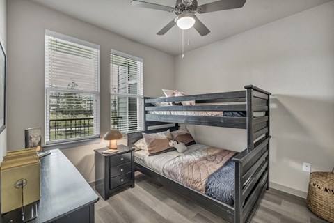 Bright secondary bedroom with comfortable furnishings, ample space, and a welcoming design suited for guests, family members, or a home office.