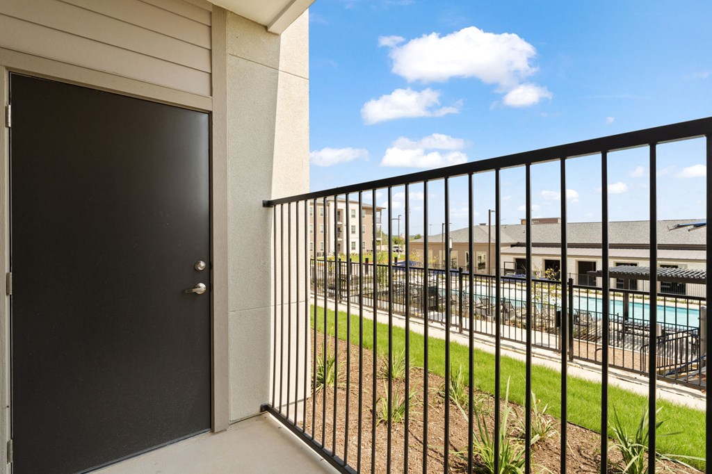the view of a pool from a balcony with a door