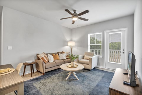 a living room with a couch and a ceiling fan
