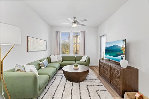 a living room with a green couch and a coffee table