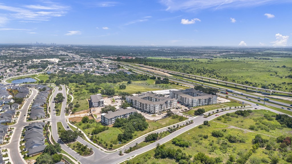 an aerial view of a city with highways and buildings