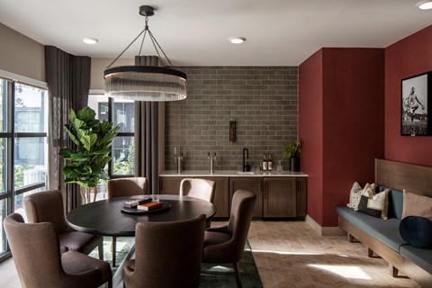 A modern dining room with a round table and chairs.