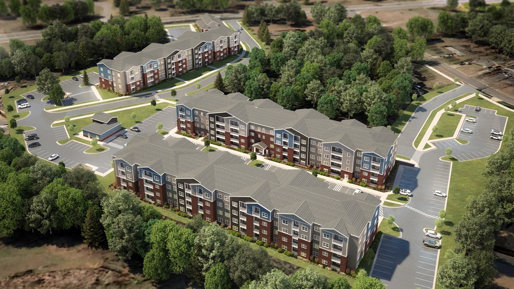 an aerial view of an apartment complex with streets and trees