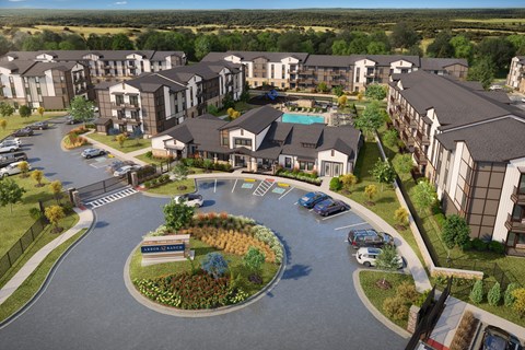 A large apartment complex with a roundabout in front.