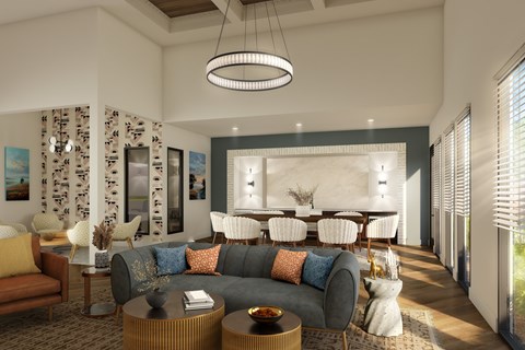 A modern living room with a grey sofa, a wooden coffee table, and a large window with blinds.