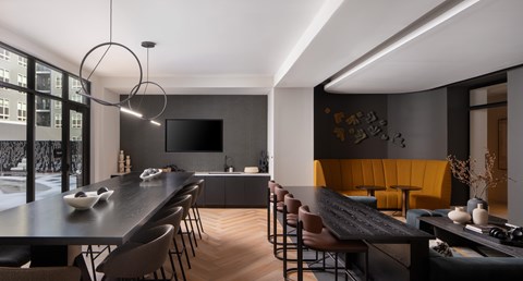 A modern  room with a long table and chairs.