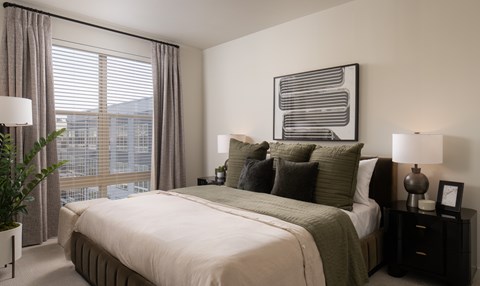 A bedroom with a large bed and window