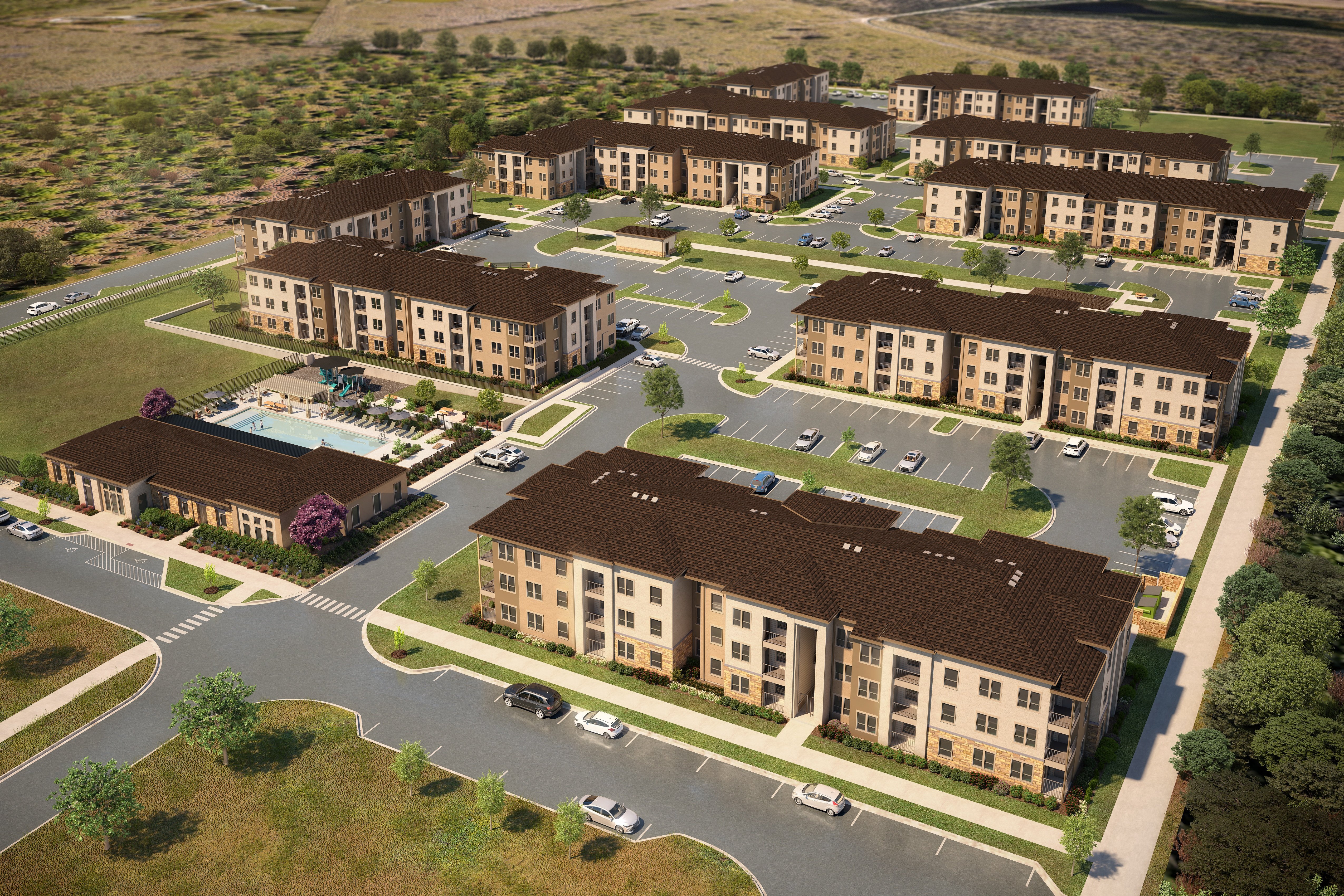 an aerial view of a development of townhouses and condominiums on a street