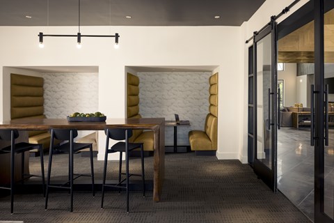 A coworking space with a wooden table and chairs.