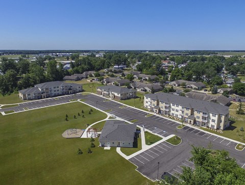 A large building complex with a parking lot in front.