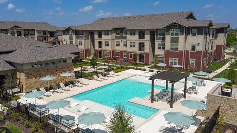 Modern apartment community featuring contemporary architecture, beautifully maintained landscaping, and inviting curb appeal.