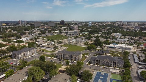 Aerial view of a modern apartment community featuring landscaped grounds, residential buildings, and thoughtfully designed outdoor spaces.