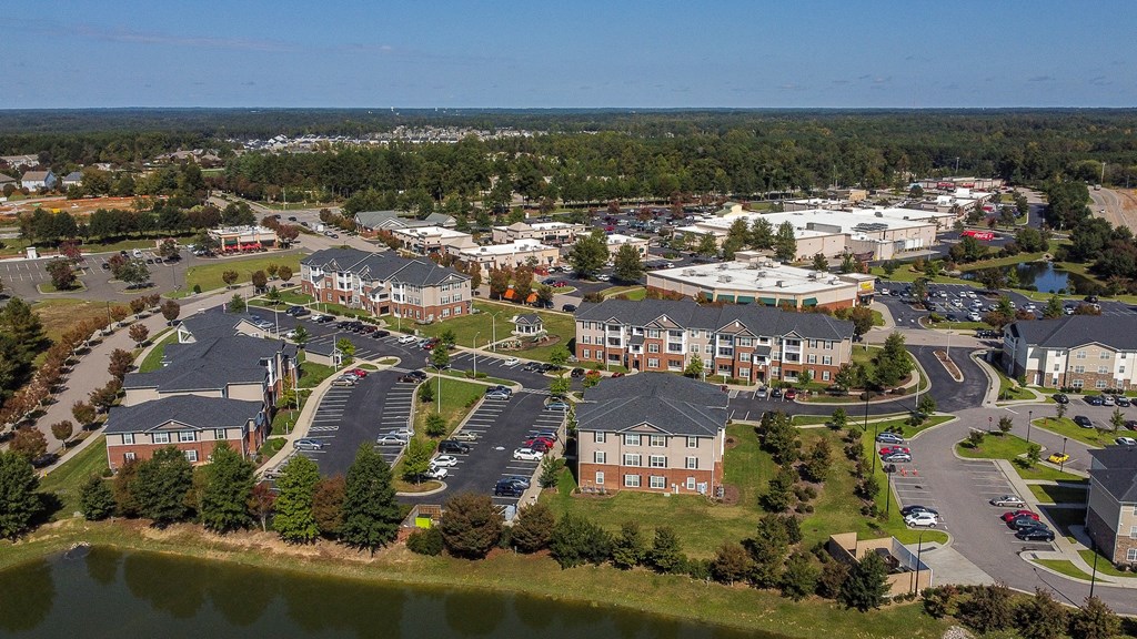 an aerial view of a city with buildings and a lake