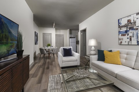 A living room with a white couch and a coffee table.