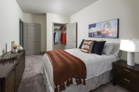Spacious primary bedroom featuring comfortable furnishings, abundant natural light, and a relaxing atmosphere designed for everyday comfort.
