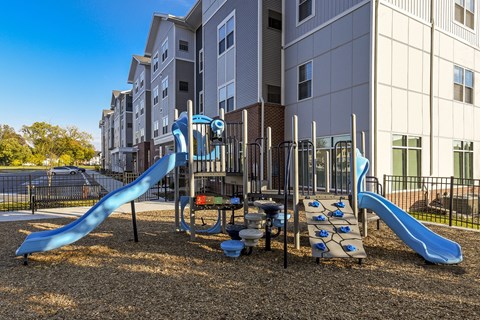 Family-friendly play area with colorful slides, interactive equipment, and a safe outdoor space for recreation.