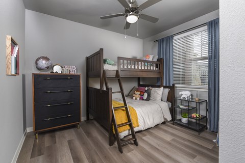 Bright secondary bedroom with comfortable furnishings, ample space, and a welcoming design suited for guests, family members, or a home office.