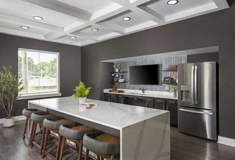 A modern kitchen with a large island and stainless steel appliances.
