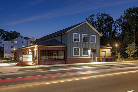 A building with a sign that says "Bank of America" is lit up at night.