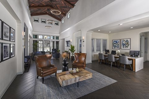 A modern living room with a wooden coffee table and leather chairs.
