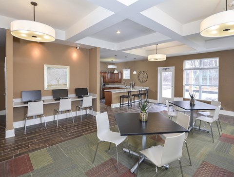 A conference room with a long table and chairs.