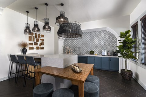 Contemporary community kitchen featuring a large island, modern appliances, and inviting gathering space for residents.